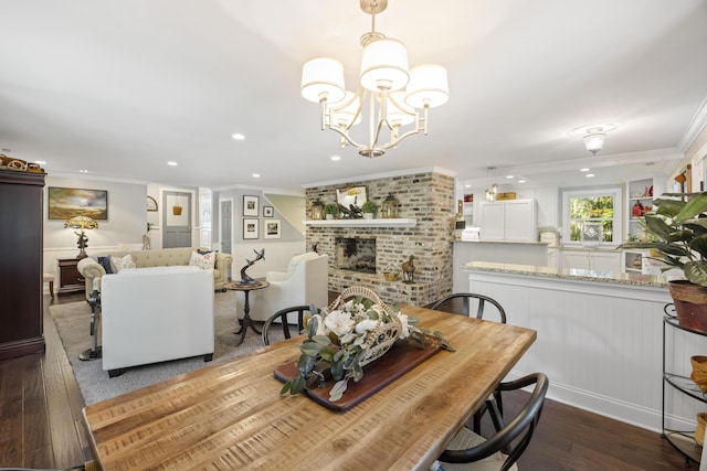 4940 Lambs Rd, North Charleston, SC 29418 - dining area featuring ornamental molding, wood finished floors, a chandelier, recessed lighting, and a fireplace