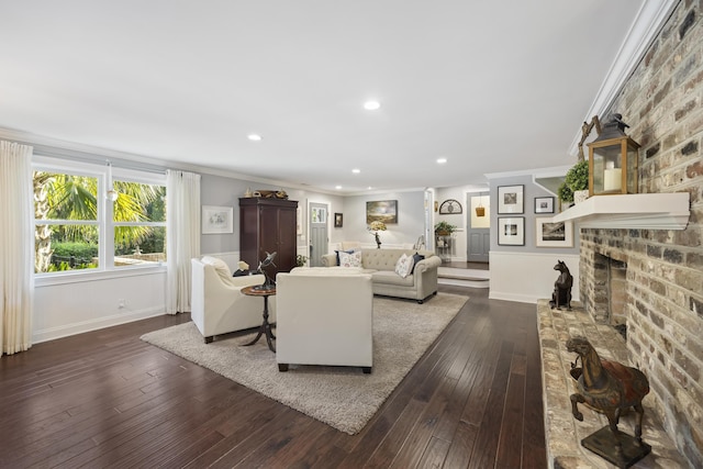 4940 Lambs Rd, North Charleston, SC 29418 - living room with dark wood-style floors, a brick fireplace, crown molding, and recessed lighting