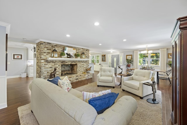 4940 Lambs Rd, North Charleston, SC 29418 - living room featuring crown molding, wood finished floors, a chandelier, a brick fireplace, and recessed lighting