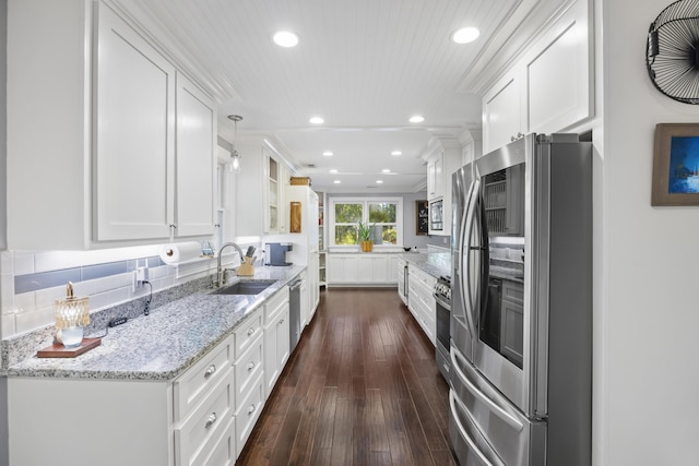 4940 Lambs Rd, North Charleston, SC 29418 - kitchen with stainless steel appliances, white cabinets, recessed lighting, dark wood-type flooring, and light stone countertops