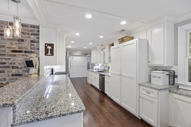4940 Lambs Rd, North Charleston, SC 29418 - kitchen with crown molding, appliances with stainless steel finishes, white cabinetry, dark wood finished floors, and light stone countertops