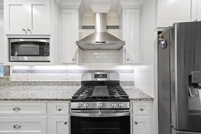 4940 Lambs Rd, North Charleston, SC 29418 - kitchen with appliances with stainless steel finishes, wall chimney exhaust hood, white cabinetry, and decorative backsplash