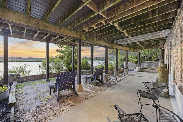 4940 Lambs Rd, North Charleston, SC 29418 - patio terrace at dusk featuring a water view and a patio