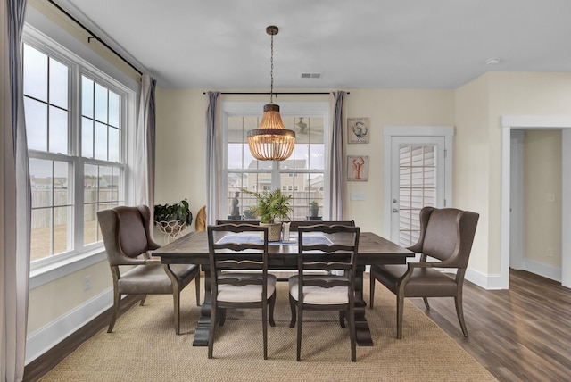 dining area featuring an inviting chandelier and hardwood / wood-style floors