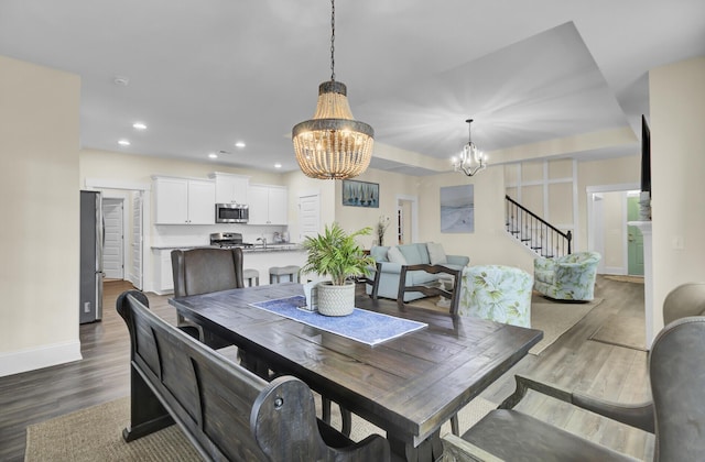 dining area featuring an inviting chandelier and dark hardwood / wood-style flooring