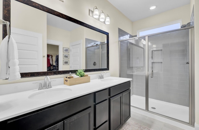 bathroom featuring an enclosed shower, vanity, and tile patterned floors