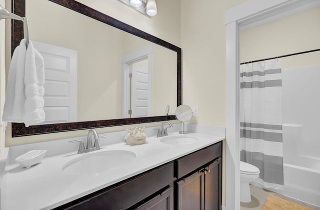 full bathroom featuring vanity, shower / bath combo with shower curtain, and toilet