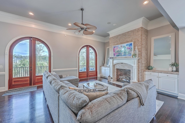 living room featuring french doors, plenty of natural light, dark wood finished floors, and a brick fireplace