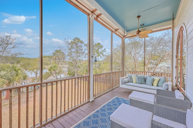 sunroom with a wealth of natural light and a ceiling fan