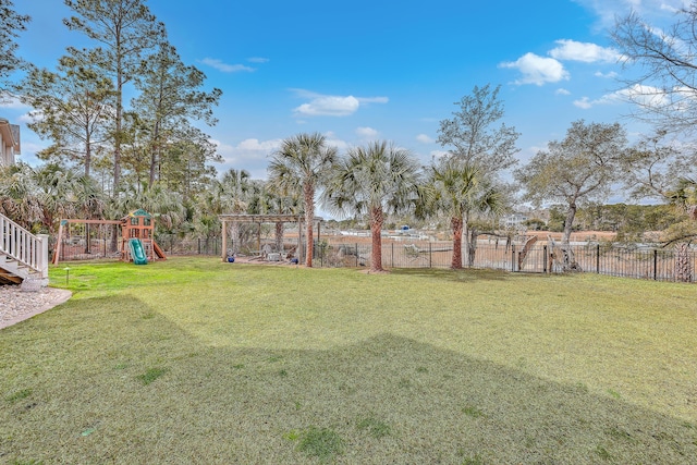 view of yard with a playground and fence