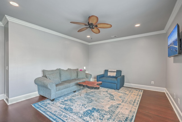 living area featuring a ceiling fan, visible vents, baseboards, and wood finished floors