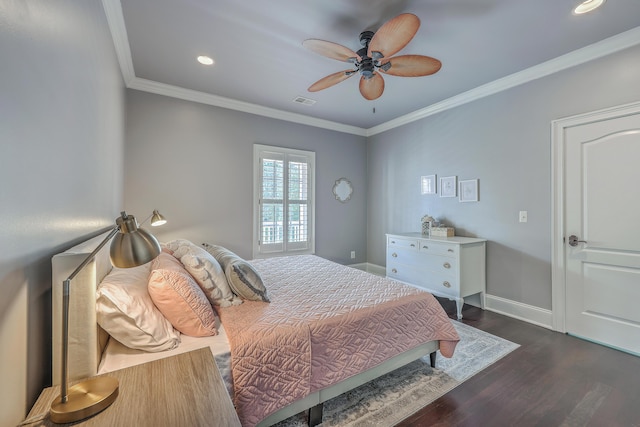 bedroom featuring visible vents, ornamental molding, ceiling fan, wood finished floors, and baseboards