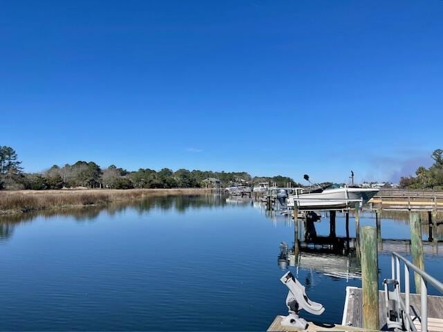 dock area with a water view and boat lift