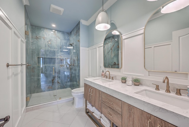 bathroom with toilet, a stall shower, visible vents, and a sink