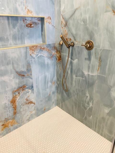 room details featuring a marble finish shower