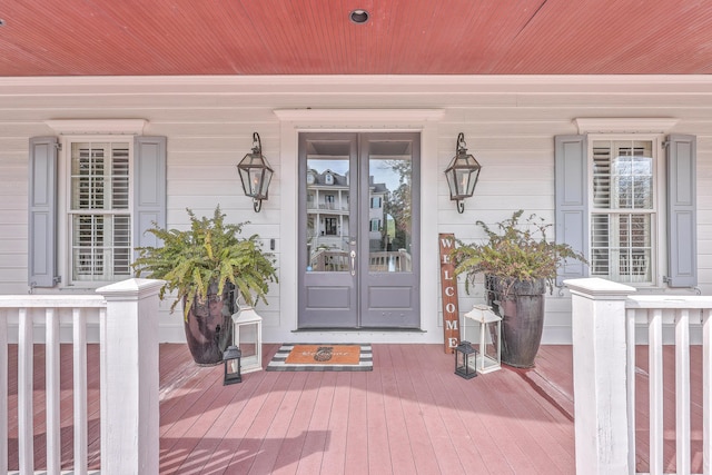 property entrance featuring a porch and french doors