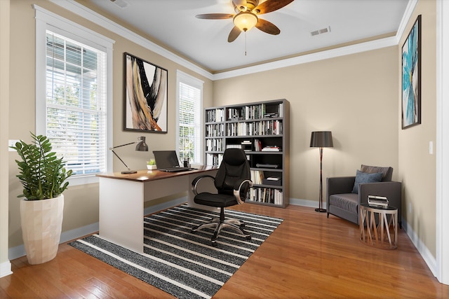 office featuring ornamental molding, a ceiling fan, baseboards, and wood finished floors