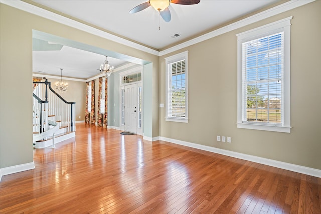 interior space featuring hardwood / wood-style flooring, visible vents, baseboards, stairs, and crown molding