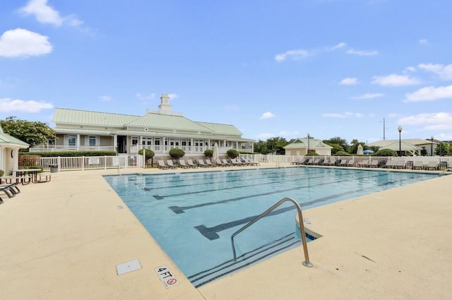 community pool featuring a patio area and fence