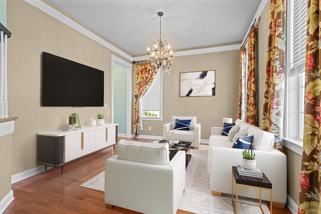 living room featuring light wood-style floors, crown molding, baseboards, and an inviting chandelier