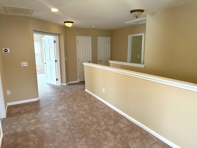 hallway with carpet floors