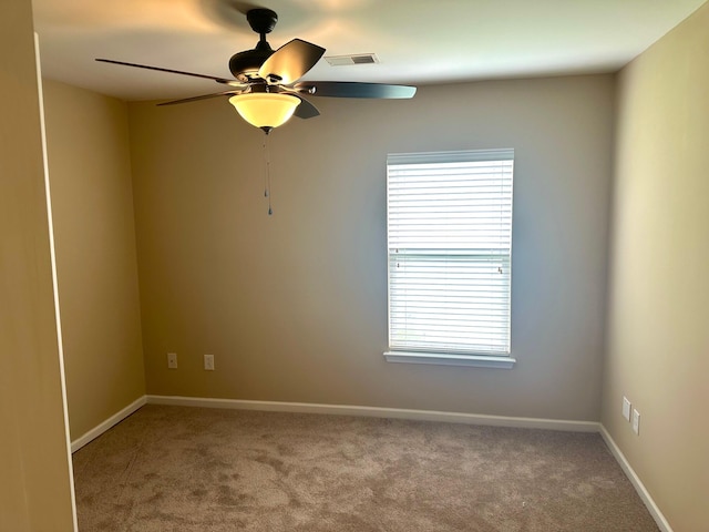 unfurnished room with carpet flooring, a wealth of natural light, and ceiling fan