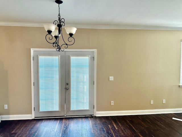 entryway featuring ornamental molding, french doors, hardwood / wood-style floors, and a chandelier