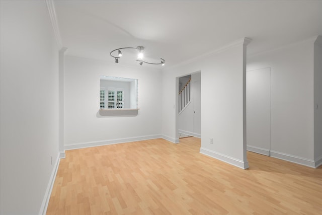 321 Lapwing Ln, Mount Pleasant, SC 29464 - empty room with ornamental molding, light wood-style floors, stairs, and baseboards