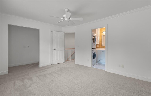 321 Lapwing Ln, Mount Pleasant, SC 29464 - unfurnished bedroom featuring estacked washer and dryer, ornamental molding, carpet, baseboards, and ensuite bathroom