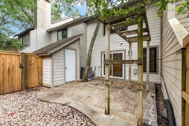 321 Lapwing Ln, Mount Pleasant, SC 29464 - back of property with central AC, a patio area, a chimney, and a gate