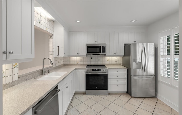 321 Lapwing Ln, Mount Pleasant, SC 29464 - kitchen featuring appliances with stainless steel finishes, a sink, light countertops, white cabinets, and backsplash