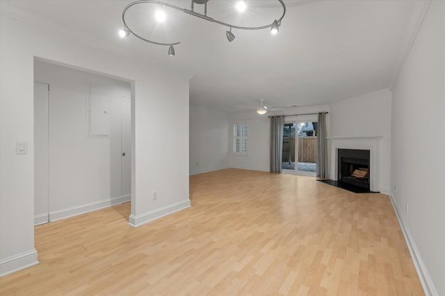 321 Lapwing Ln, Mount Pleasant, SC 29464 - unfurnished living room featuring light wood-style flooring, a fireplace, ceiling fan, and baseboards