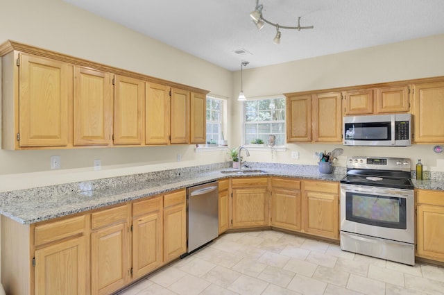 103 Trimley Ct, Goose Creek, SC 29445 - kitchen featuring stainless steel appliances, a sink, light stone countertops, hanging light fixtures, and light brown cabinetry