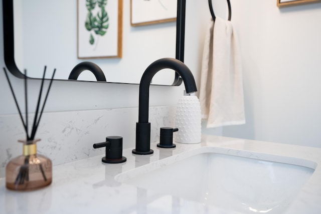 interior details featuring sink and tasteful backsplash