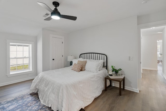 bedroom featuring ceiling fan and dark wood-type flooring