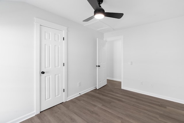 empty room with ceiling fan and dark hardwood / wood-style flooring