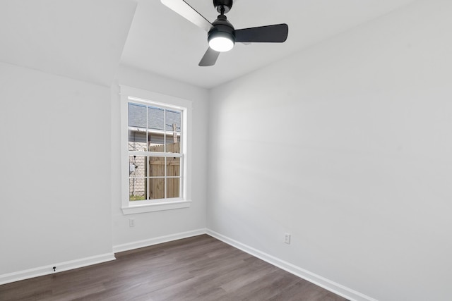 empty room featuring ceiling fan and dark hardwood / wood-style floors