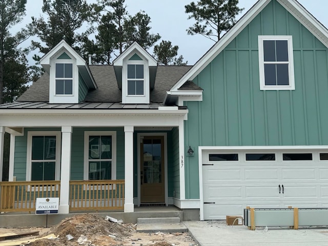 view of front of home featuring roof with shingles, covered porch, board and batten siding, a standing seam roof, and a garage