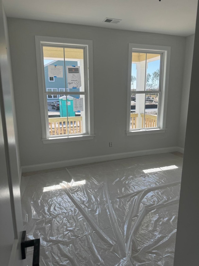 spare room with visible vents and baseboards