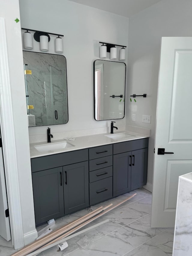 bathroom with double vanity, marble finish floor, a marble finish shower, and a sink