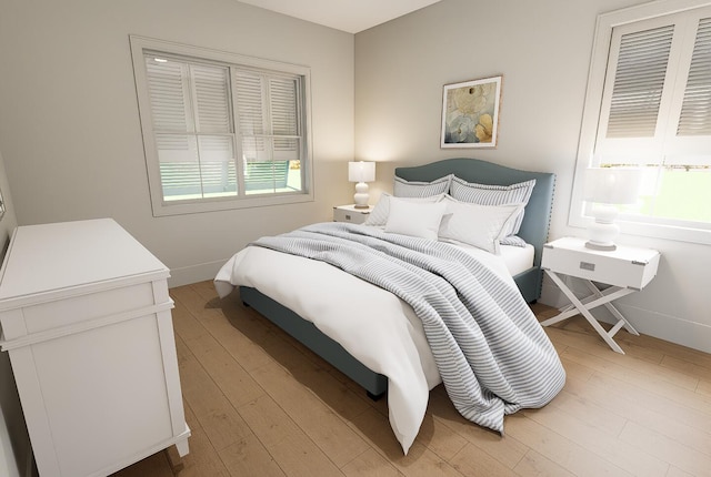 bedroom with light wood-style flooring and baseboards