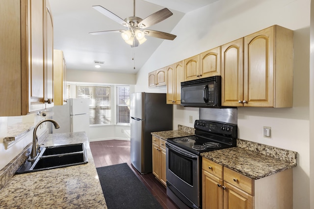 kitchen featuring lofted ceiling, stone counters, sink, range with electric stovetop, and white refrigerator