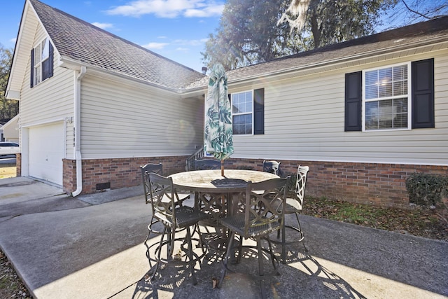 view of patio / terrace featuring a garage