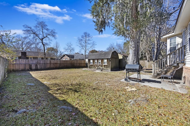 view of yard with a storage unit and a patio