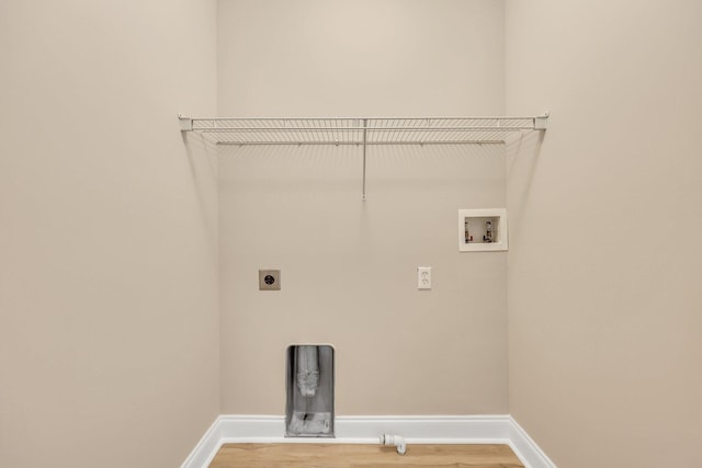 laundry area with electric dryer hookup, hookup for a washing machine, and wood-type flooring