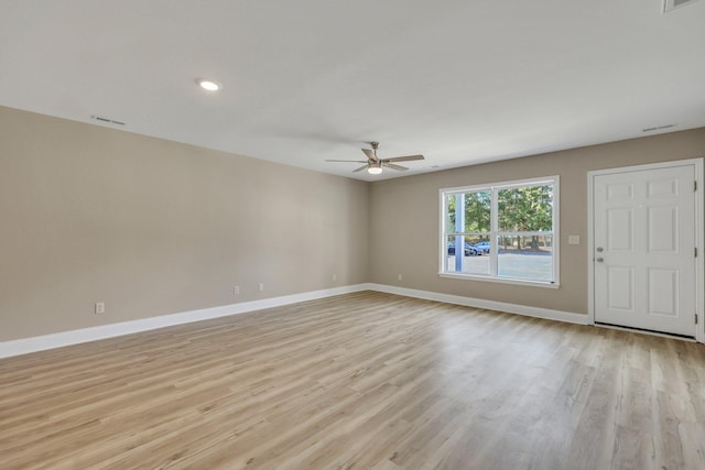 spare room featuring ceiling fan and light hardwood / wood-style flooring