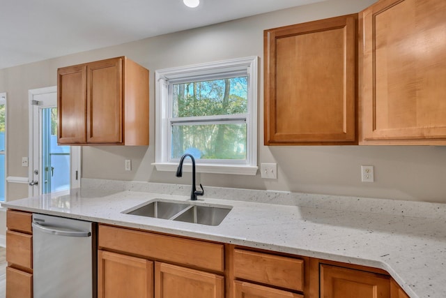 kitchen with light stone countertops and sink