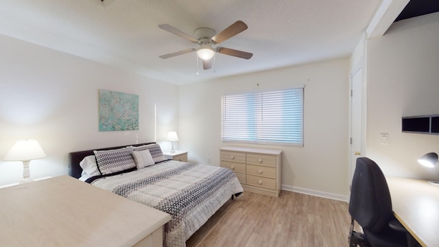 bedroom with ceiling fan and light wood-type flooring