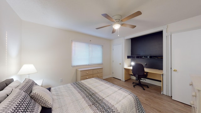 bedroom featuring ceiling fan, a closet, and light wood-type flooring