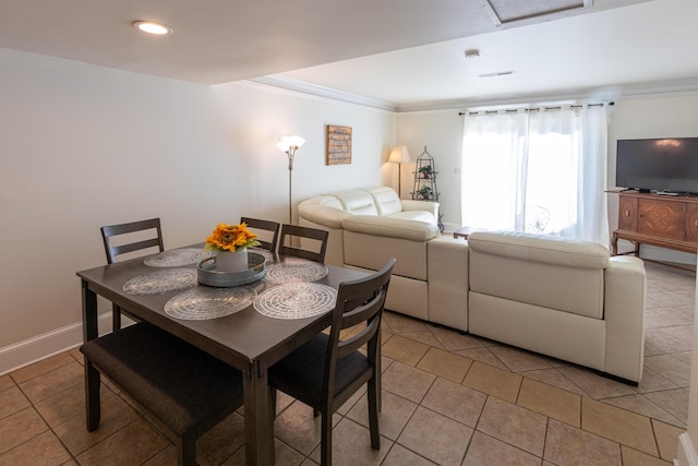 tiled dining area featuring ornamental molding